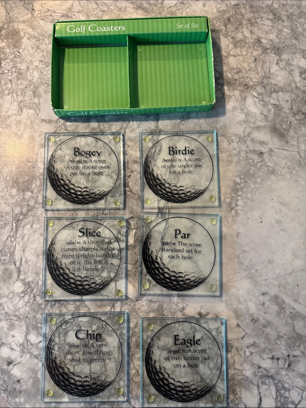 Set of 6 tempered glass coasters. Each coaster depicts golf ball terms.